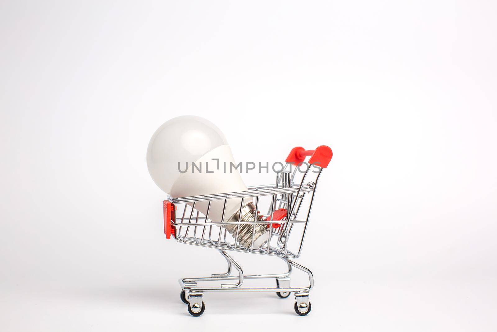 LED light bulbs on a cart, Isolated on white background. The concept of selling and buying business ideas, saving energy and cash