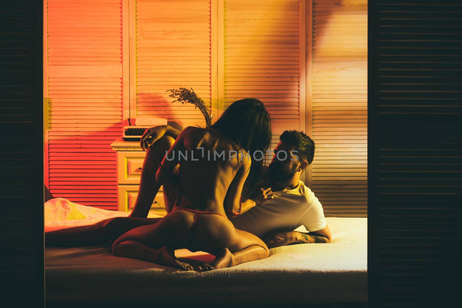 Passion couple. Romantic sensual people. Close-up of happy couple is lying in bed together. Enjoying the company of each other