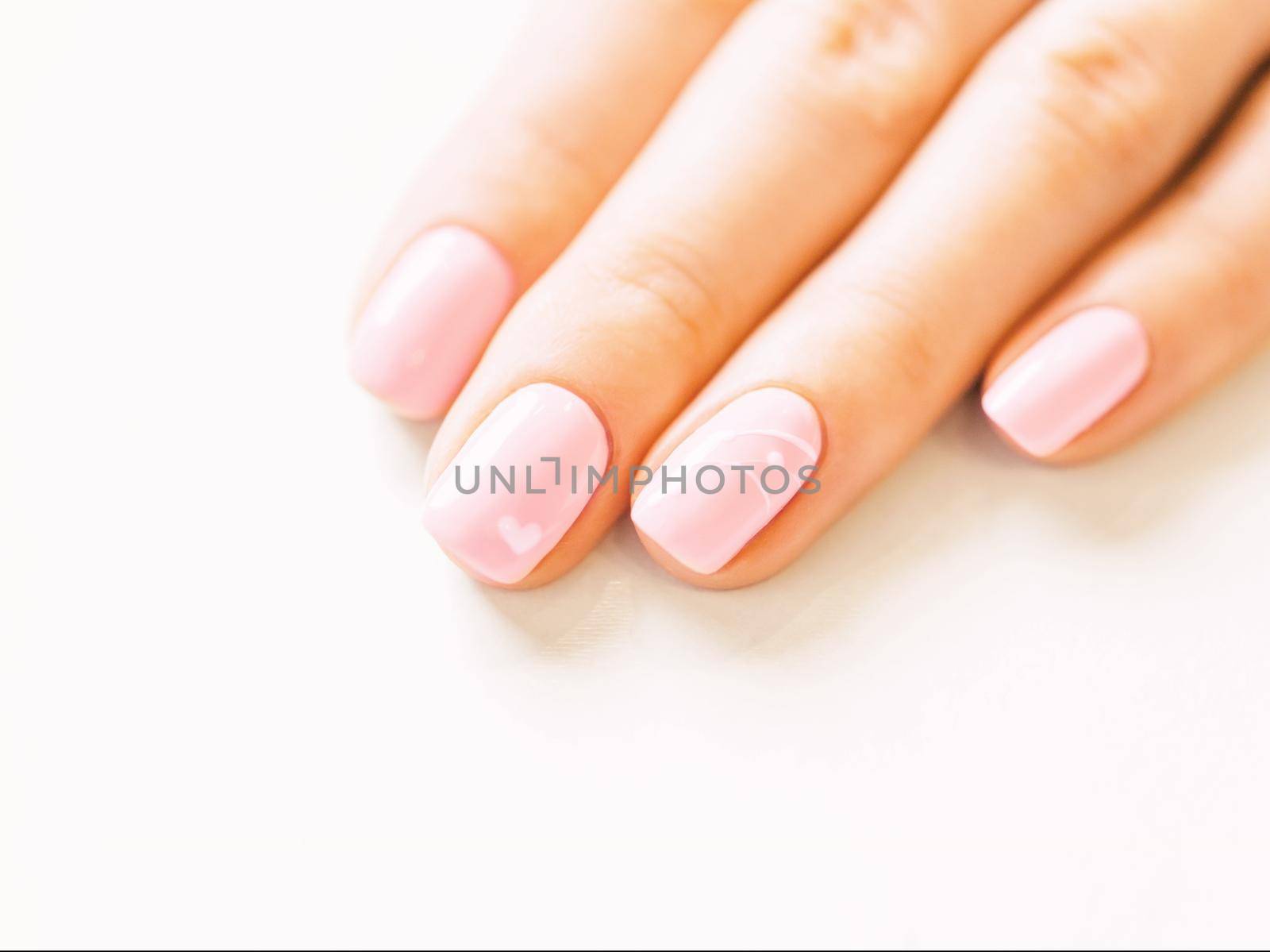 Female hand with stylish manicure of pink color. by alexAleksei