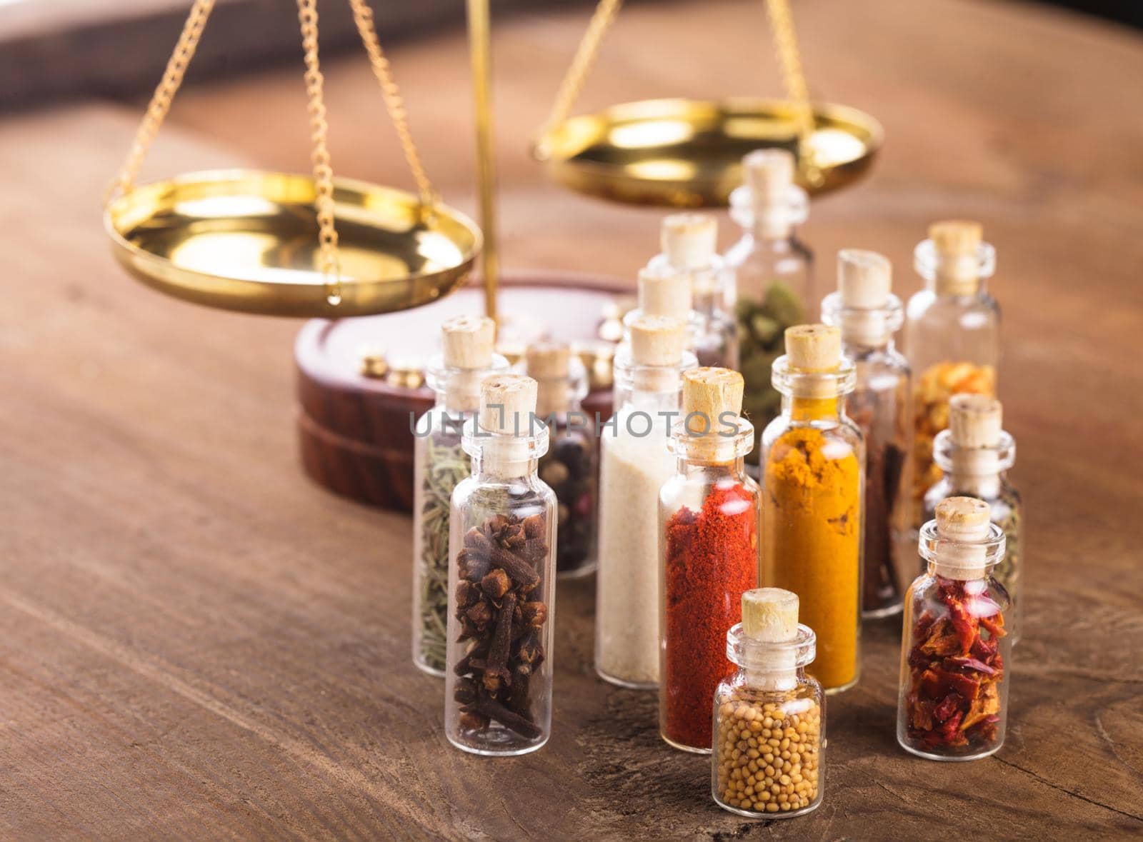 Little bottles with spices and scales on the table