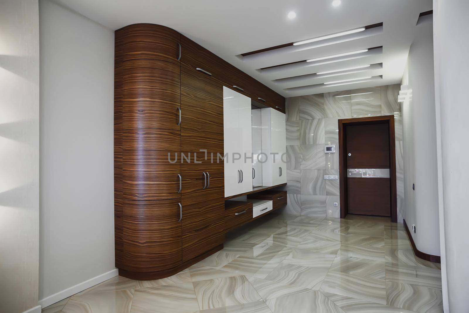 Wooden cabinet in modern hallway interior with luxury marble floor