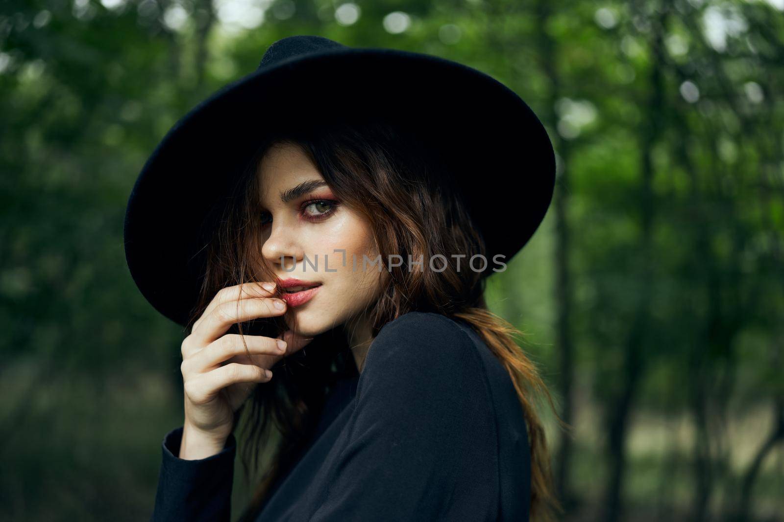 woman dressed as a witch in the forest Halloween fantasy ritual. High quality photo