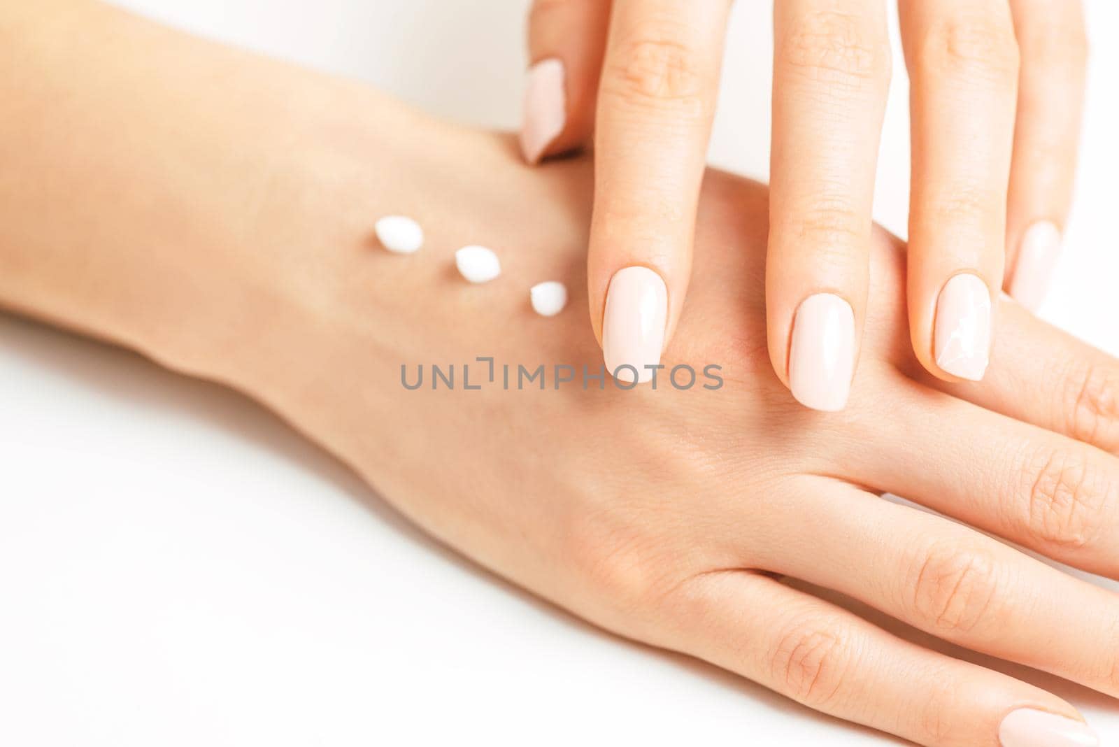 Female hands applying moisturizing cream for smooth skin. by alexAleksei