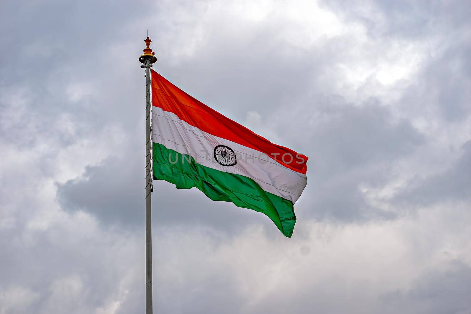 Indian National Flag , flying high in the sky on a cloudy background. by lalam