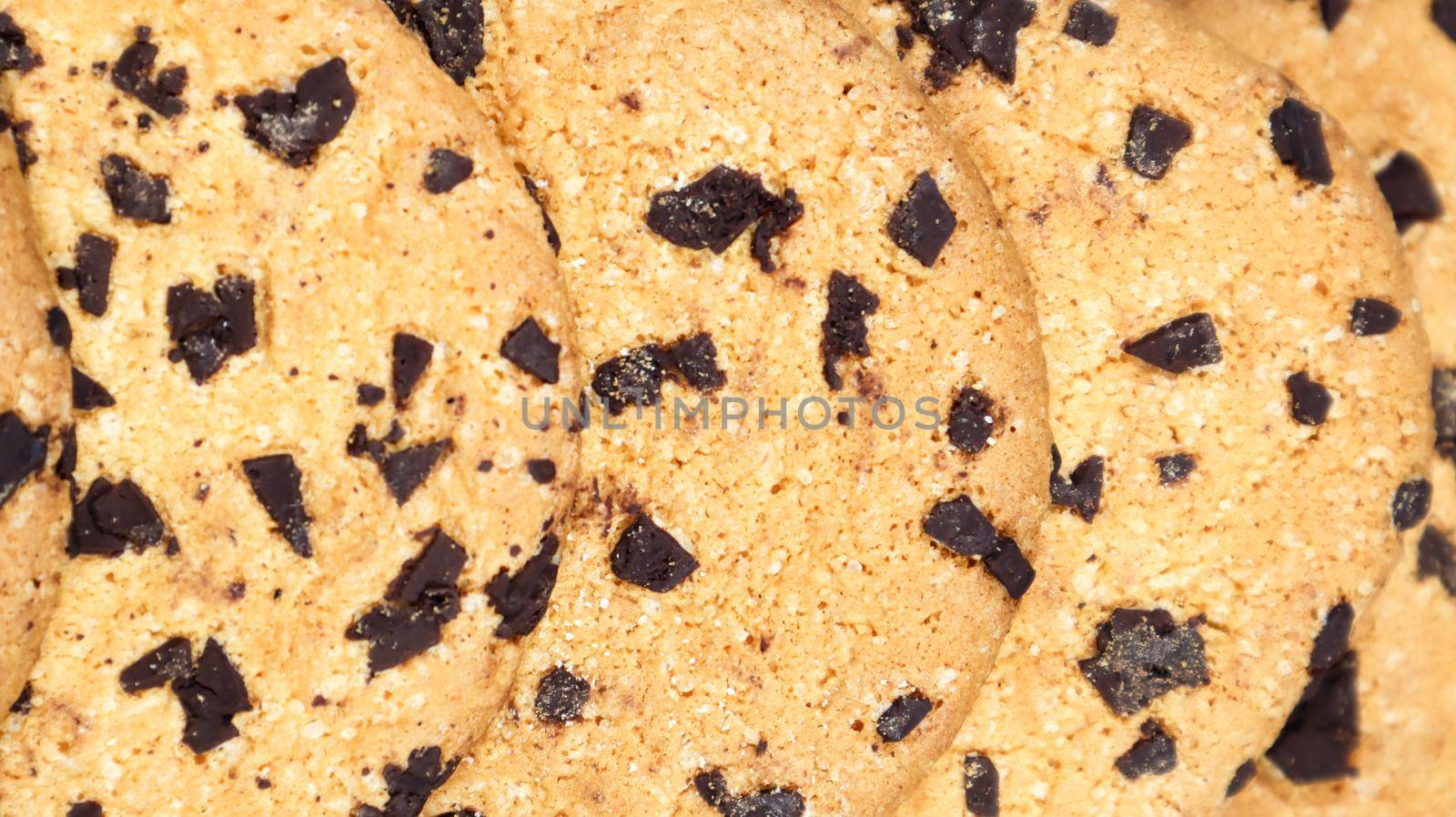 Soft, freshly baked chocolate chip cookies on a gray marble kitchen countertop. American traditional sweet pastry pastry, delicious homemade dessert. Culinary background. Close-up.