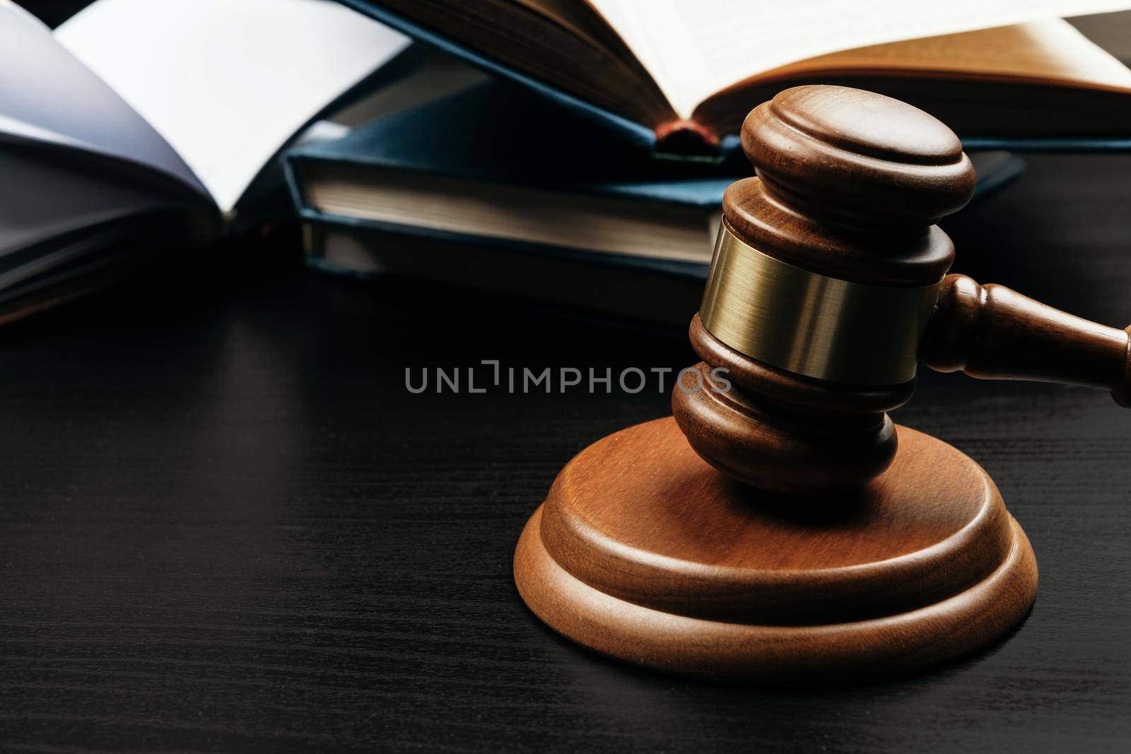 Judge's gavel on wooden table in dark. High quality photo
