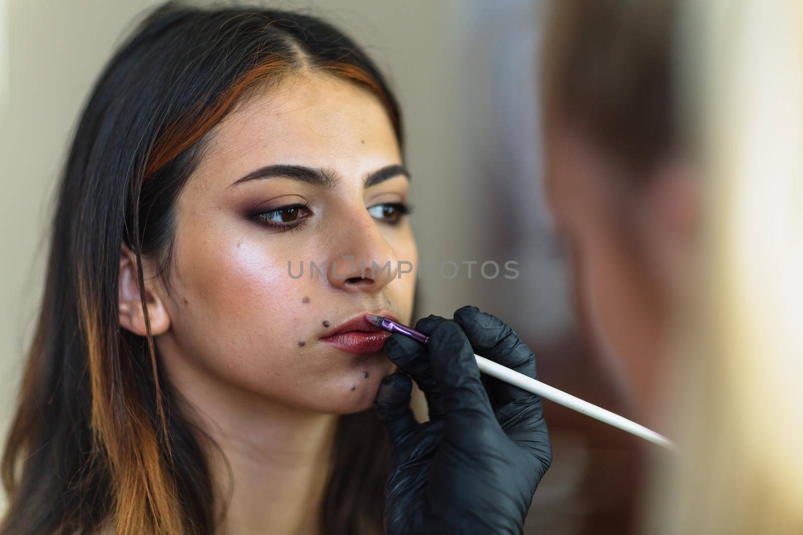 Makeup woman artist at work, professional in action, beauty salon and creative classes by OnPhotoUa