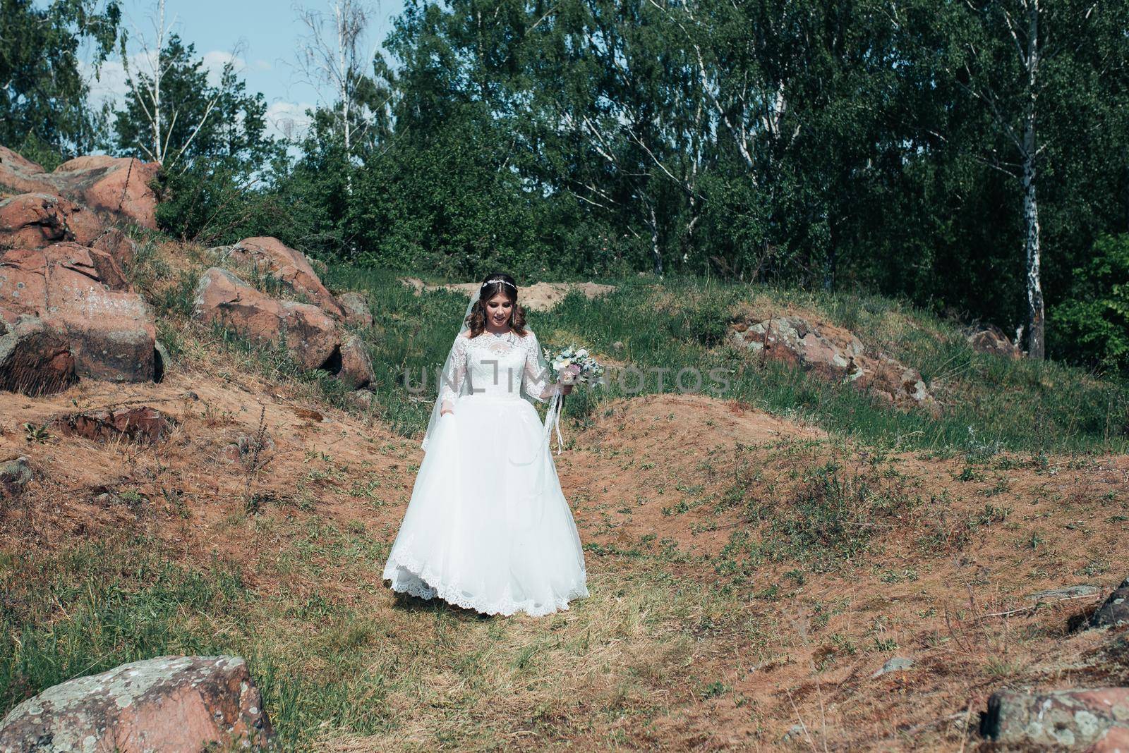 Wedding photography in rustic style emotions of the bride on the nature on the rocks. by lunarts