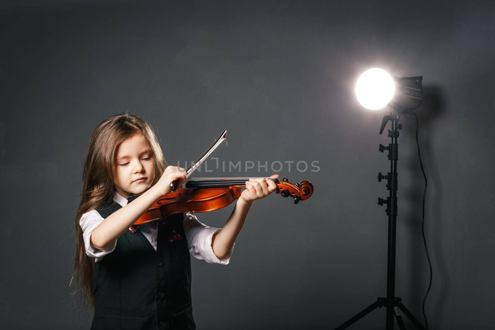 Beautiful girl with long hair playing violin