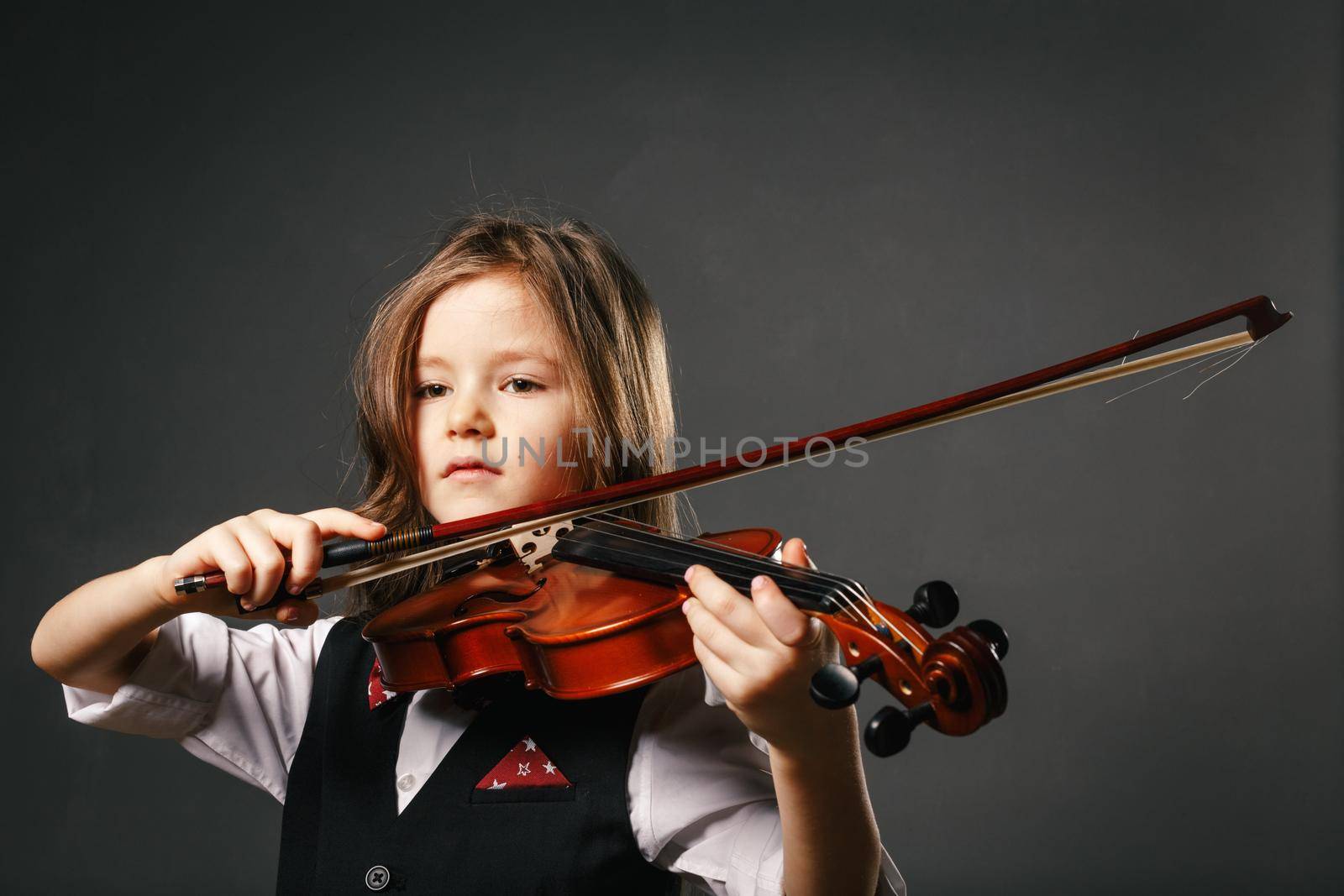 Beautiful girl with long hair playing violin