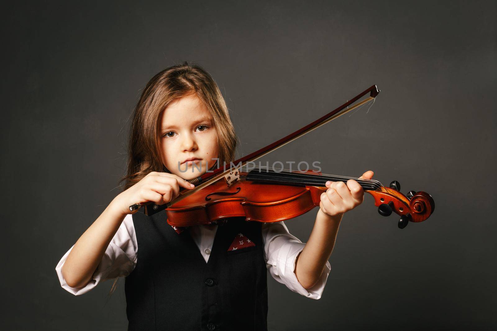 Beautiful girl with long hair playing violin