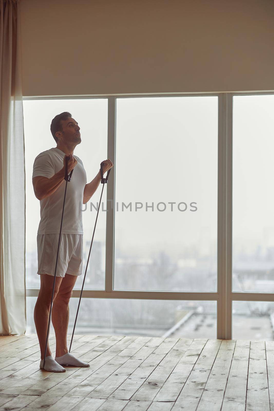 Athletic man training at home during quarantine by Yaroslav_astakhov