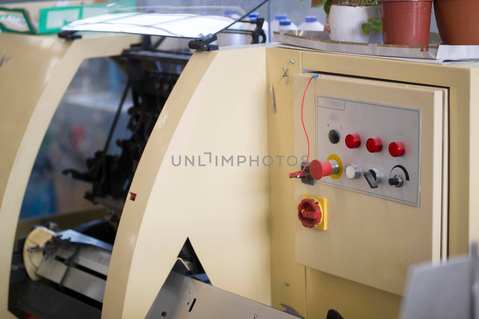Control panel of the print press machine with buttons at printing factory, close up