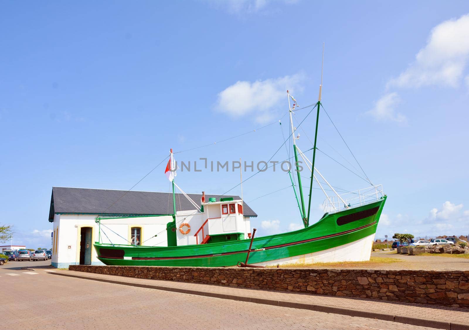 Old green fishing boat aground in France