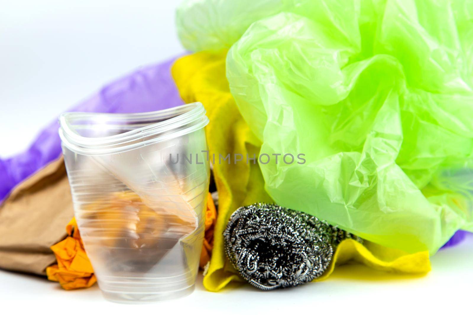 Concept of garbage and pollution. A pile of trash, crumpled plastic cup, packages, paper isolate on a white background.