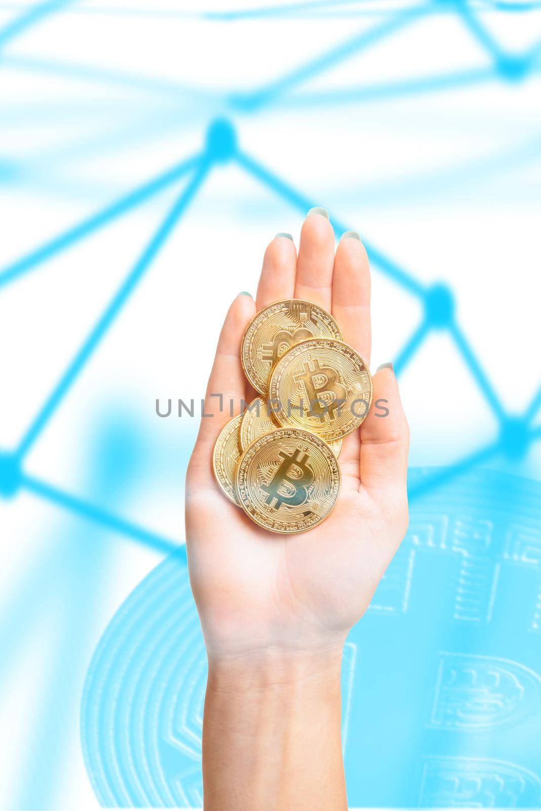 Bitcoins coins on female palm hand on background of blockchan scheme. by alexAleksei