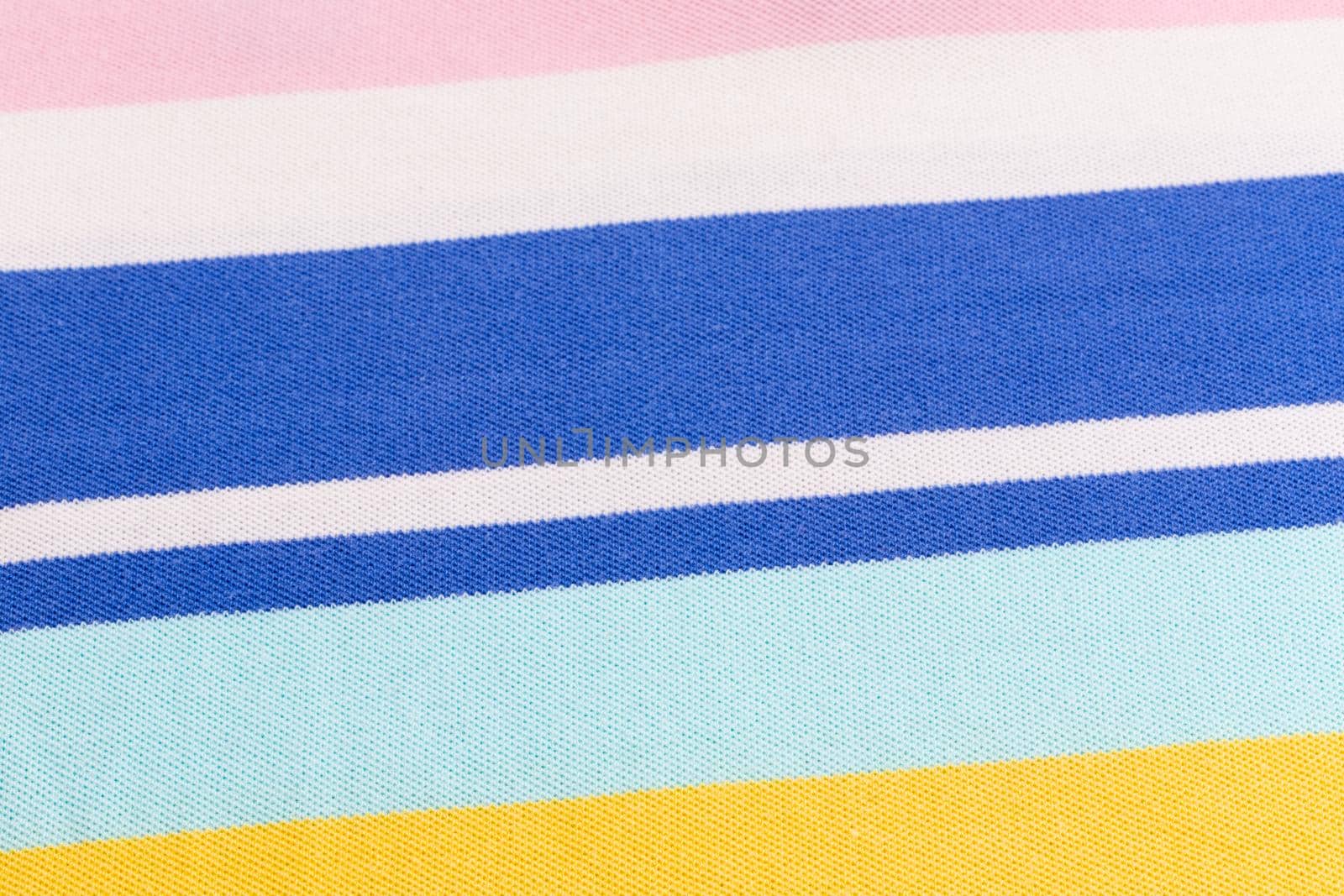 Beautiful summer background made of striped fabric of delicate colors blue, yellow, pink.