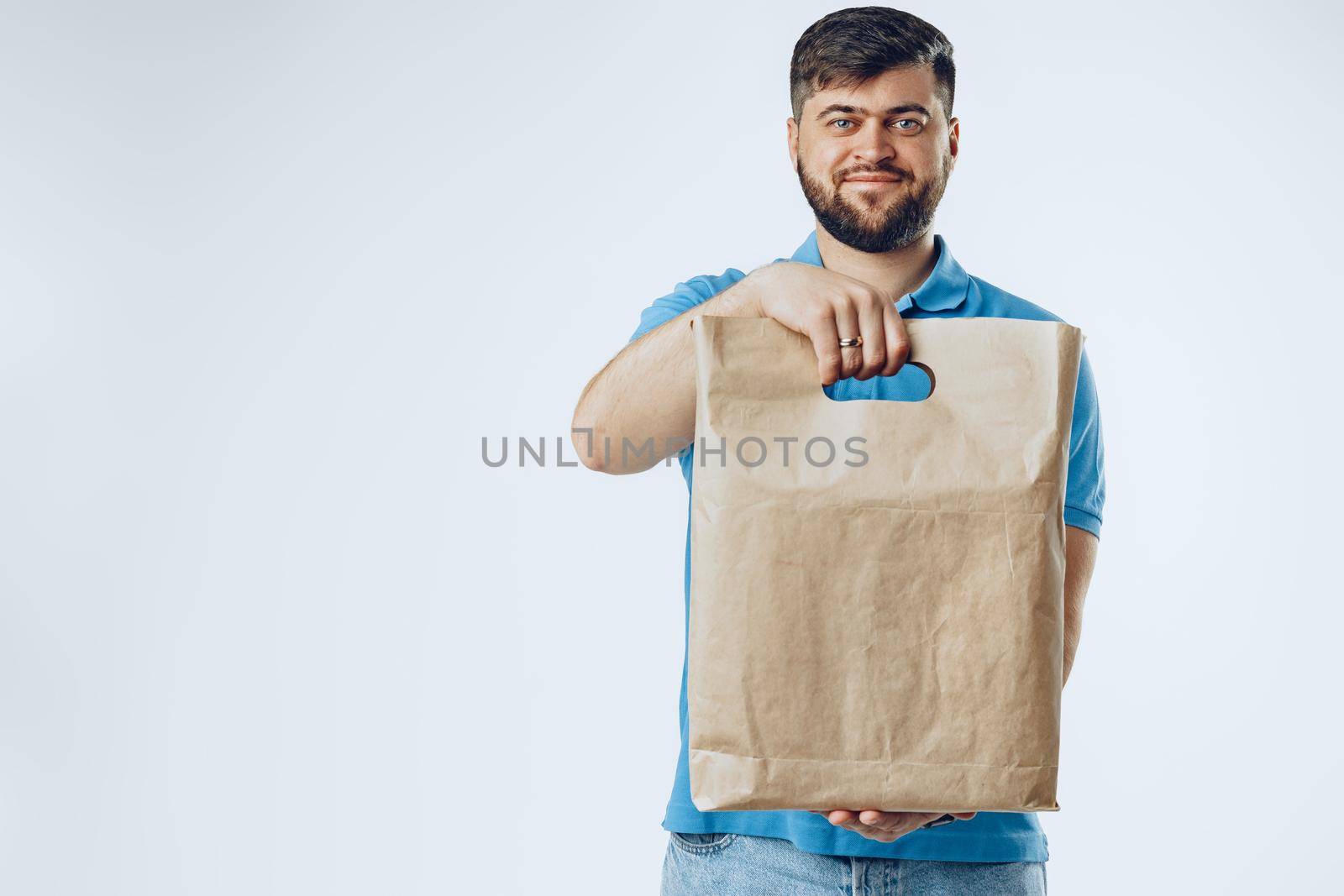 Food delivery courier with order on light grey background