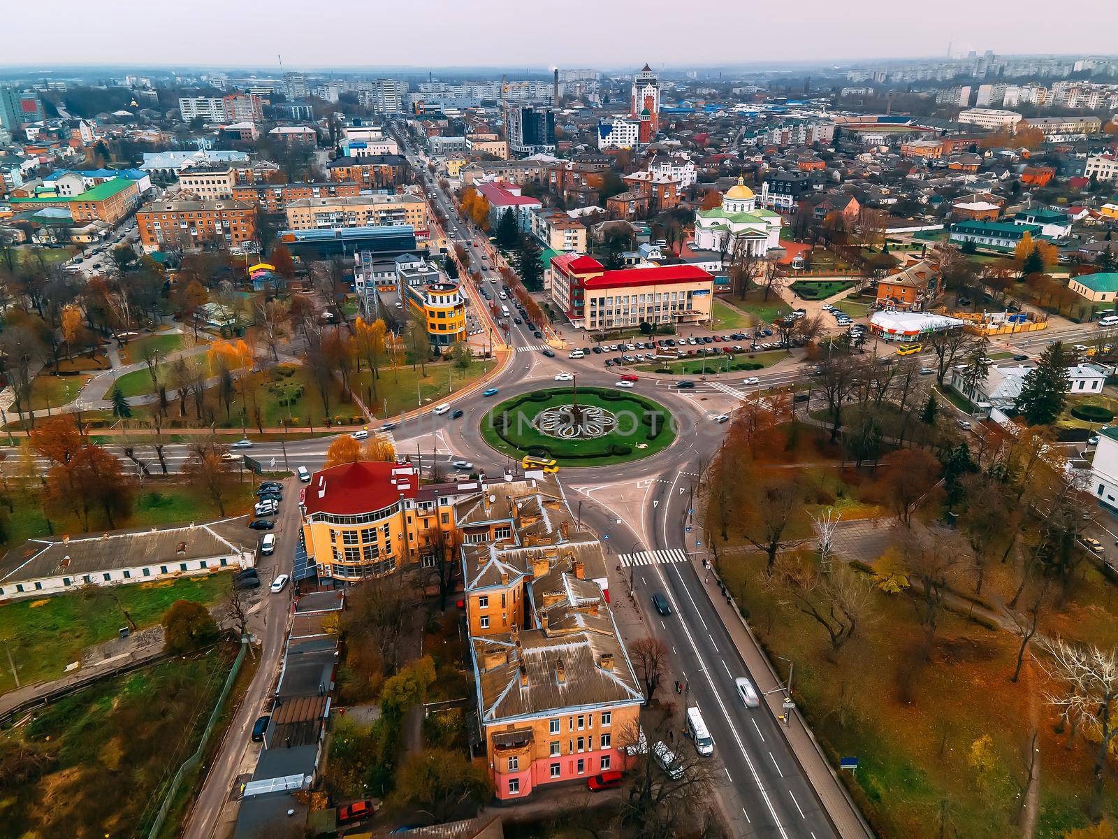 Aerial view of roundabout road with circular cars in small european city at autumn cloudy day, Kyiv region, Ukraine