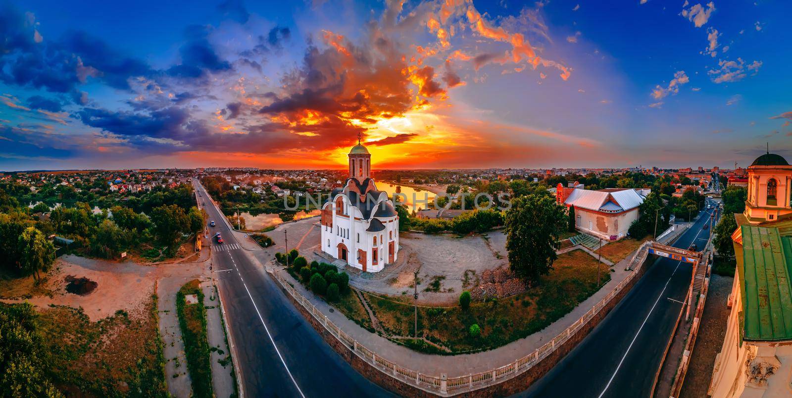 Panoramic aerial view of old church near river and bridge in small european city at summer day, Kyiv region, Ukraine