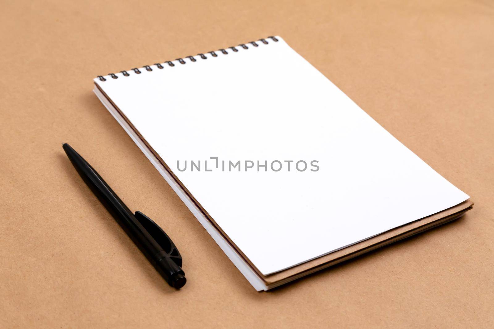 Stationary concept, Flat Lay top view Photo of pencil and notepad on a beige abstract background with copy space, minimal style