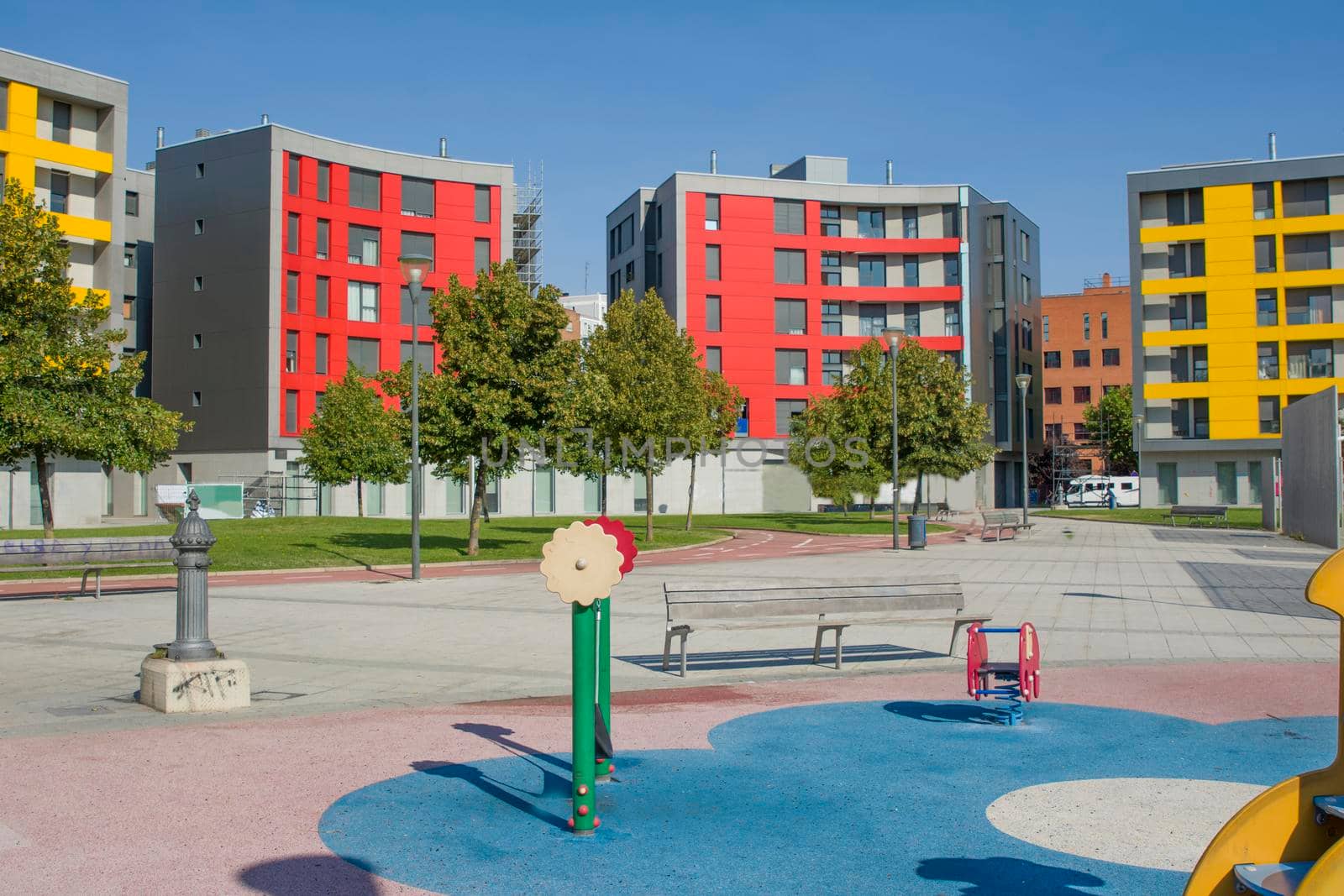 Colorful modern houses with apartments and a children's playground