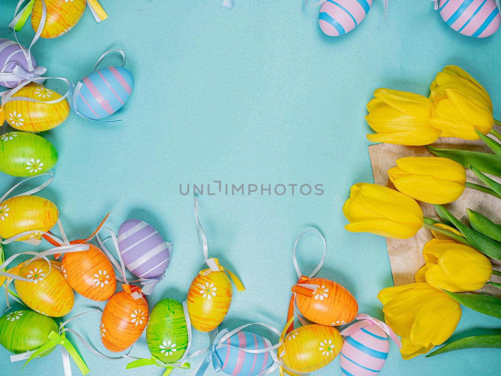 Easter holiday celebration at Coronavirus pandemic. Covid19 protective masks, Easter eggs and tulips on wooden table background