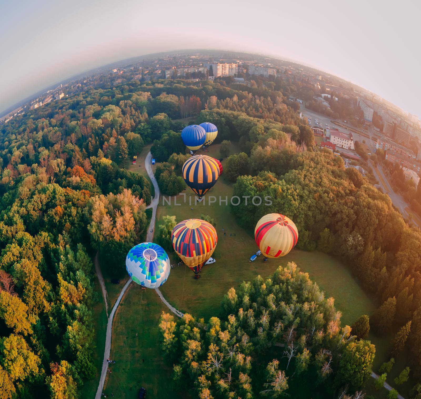 Panoramic air view of hot air ballons prepare for an early morning takeoff from park in small european city, Kiev region, Ukraine
