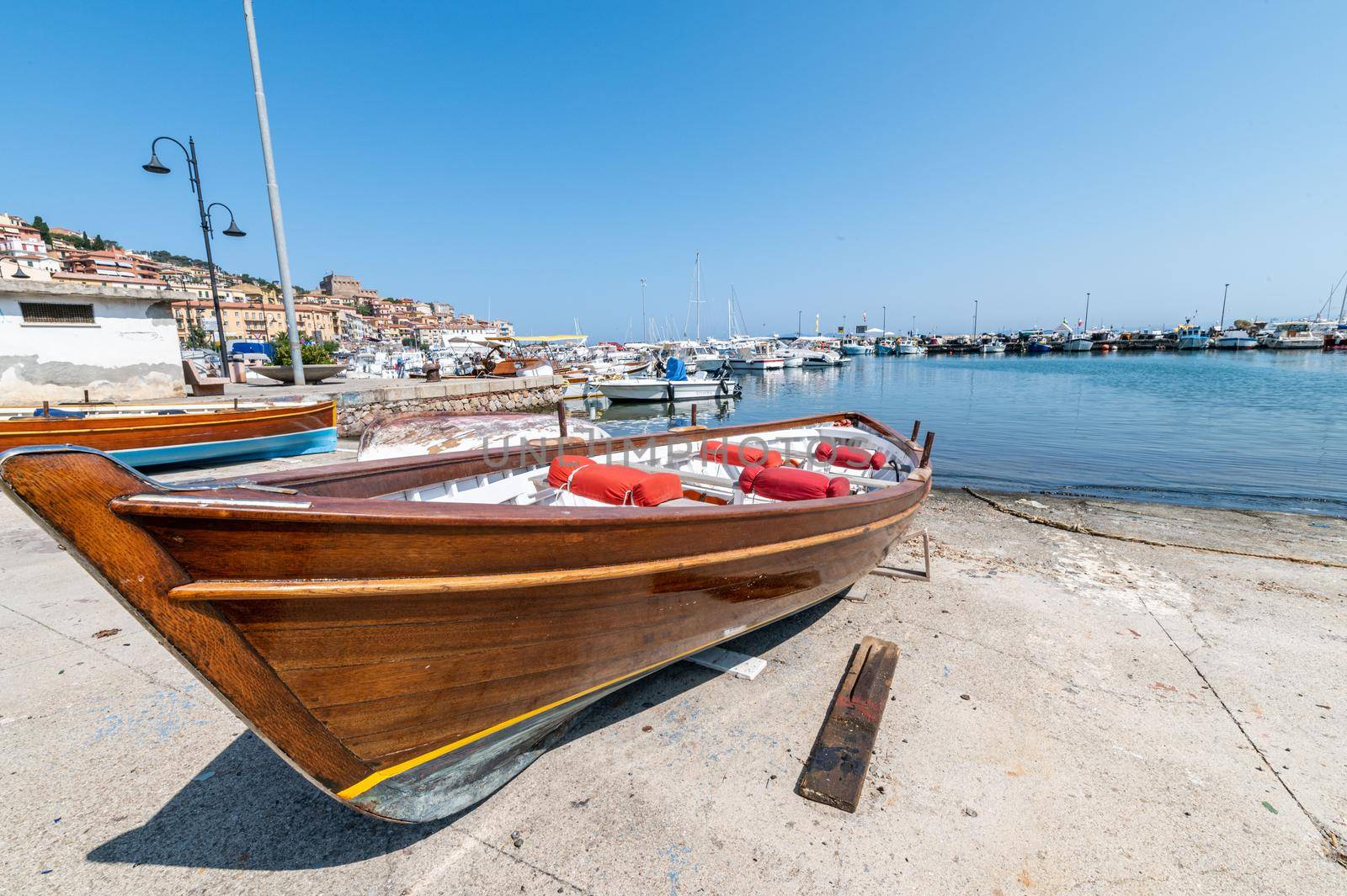 wooden boat on the lolo of porto santo stefano in the summer