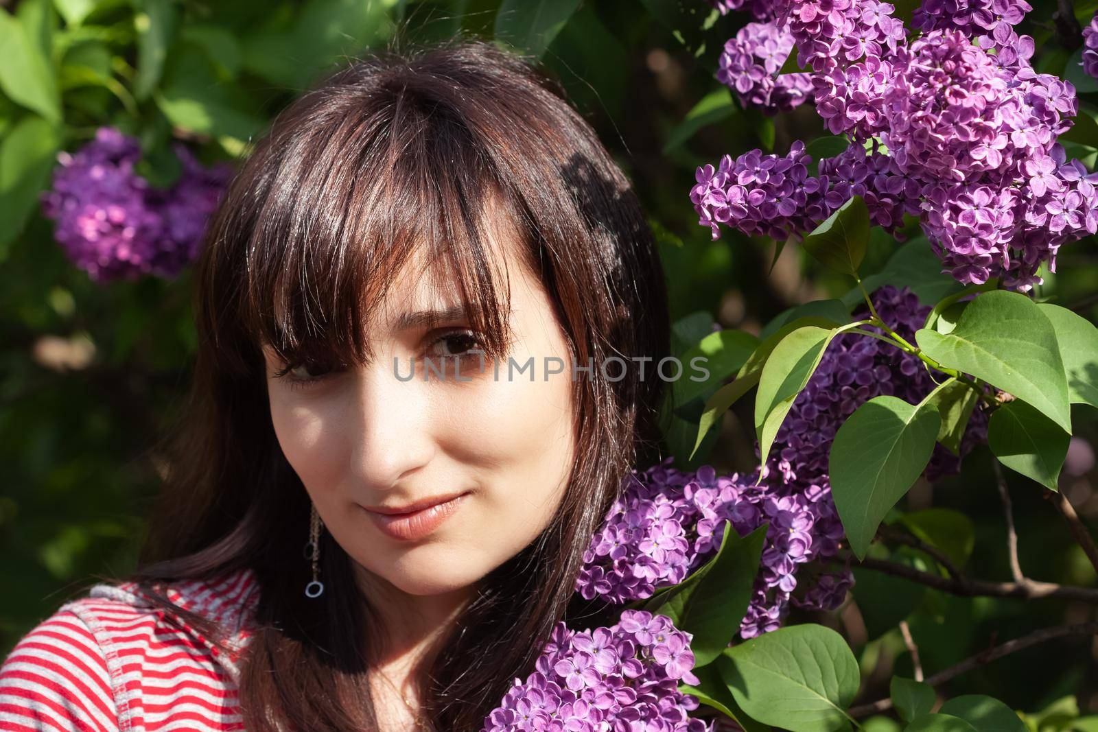 woman posing among blooming lilacs by palinchak