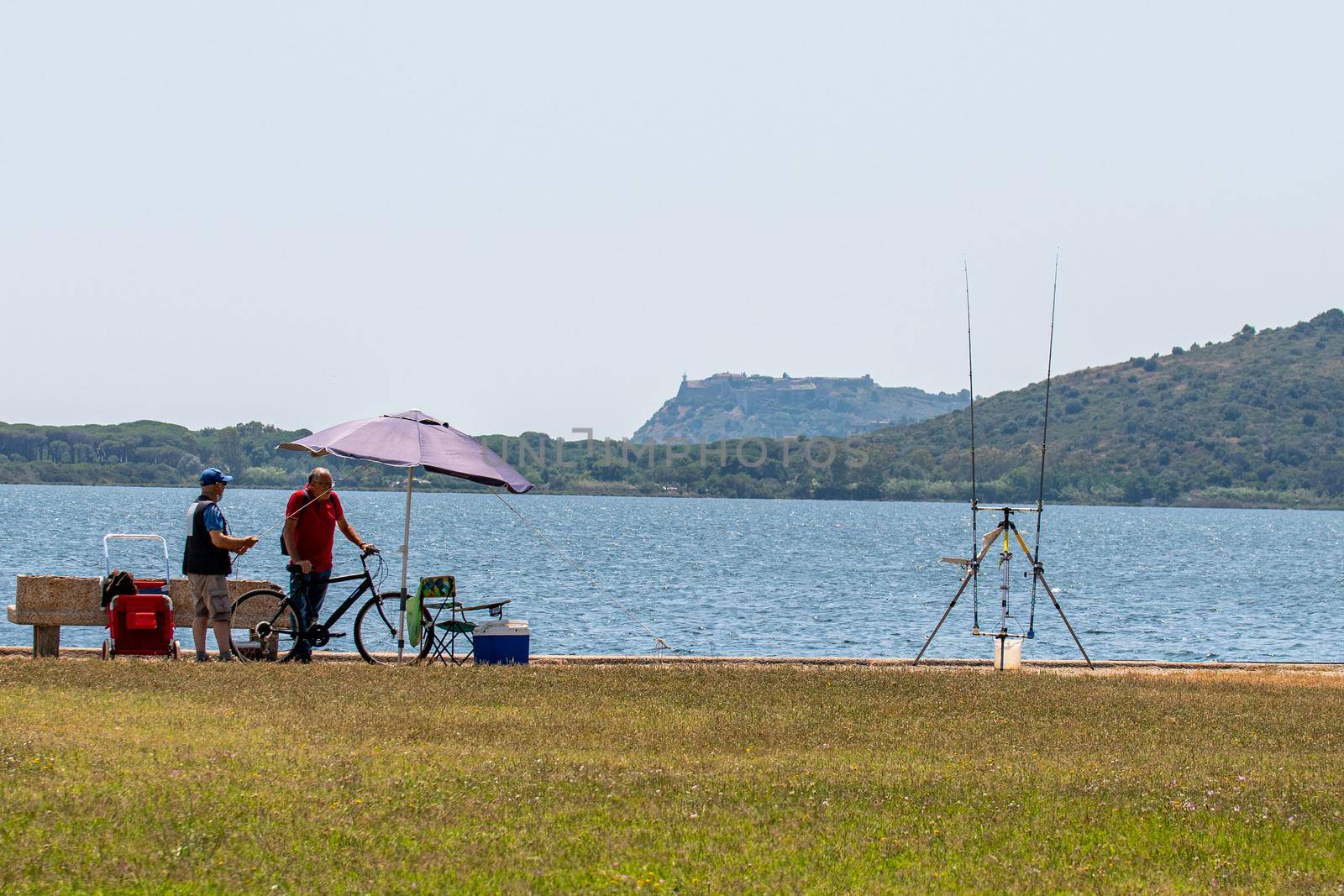 orbetello,italy july 24 2021:fisherman on the shores of the sea in Orbetello