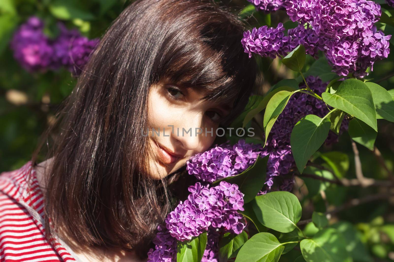 woman posing among blooming lilacs by palinchak