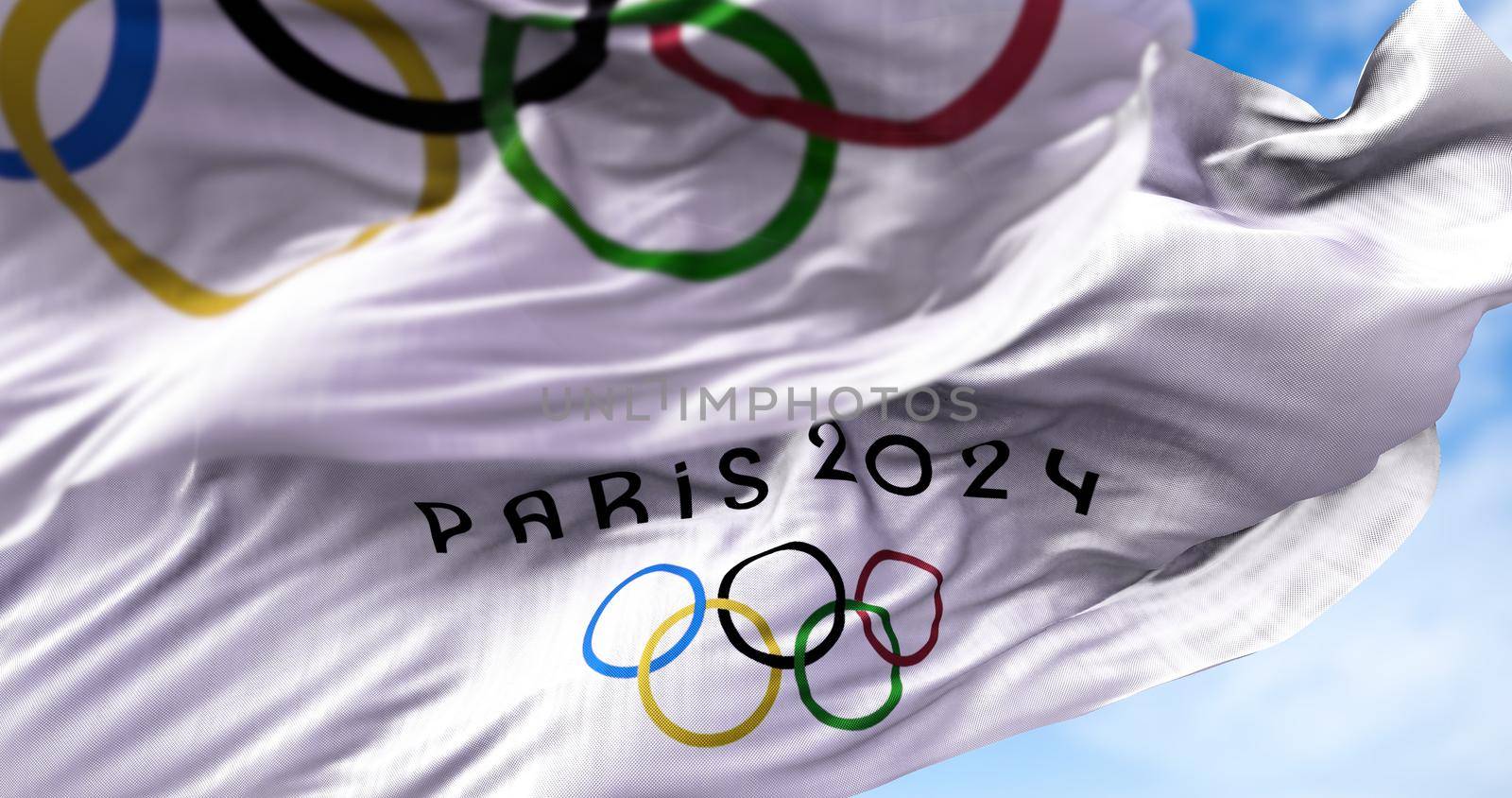 Tokyo, Japan, July 2021: Paris 2024 flag waving in the wind with the Olympic flag blurred in the foreground by rarrarorro