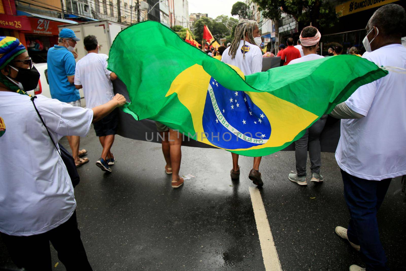 salvador, bahia, brazil - july 24, 2018: protester carries the Brazilian flag during protest against the government of President Jair Bolsonaro in the city of Salvador.