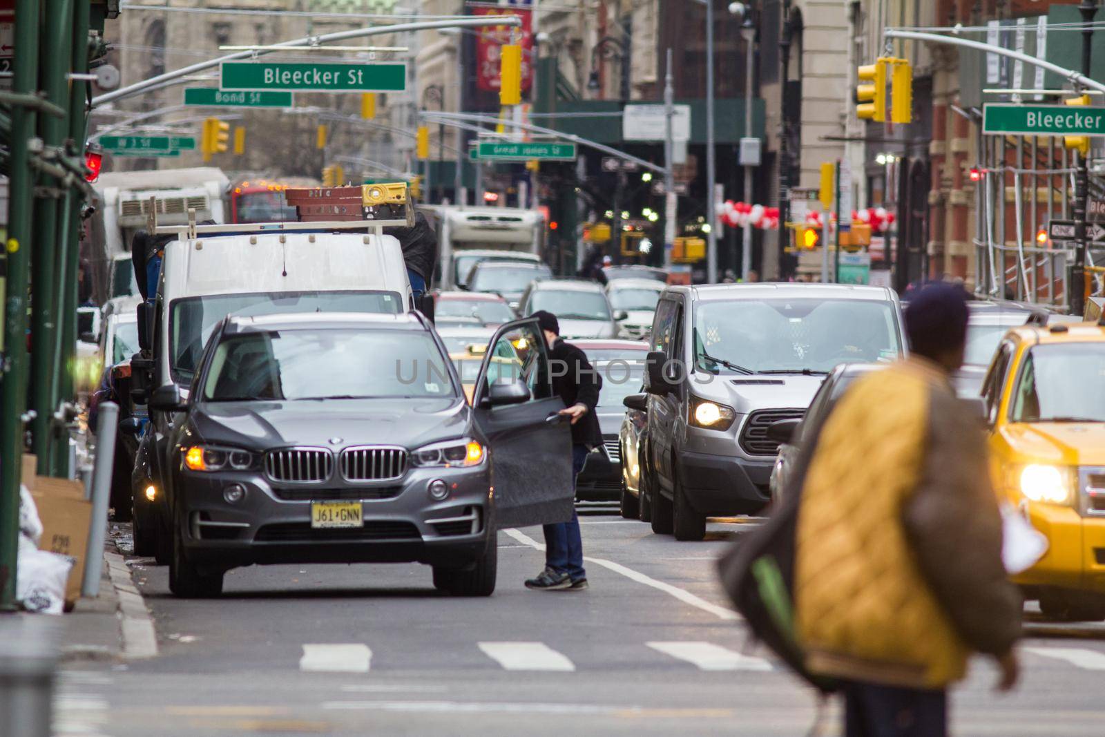 NEW YORK, USA - Decembre 2017: busy road in a big city with lots of cars and people, urban landscape