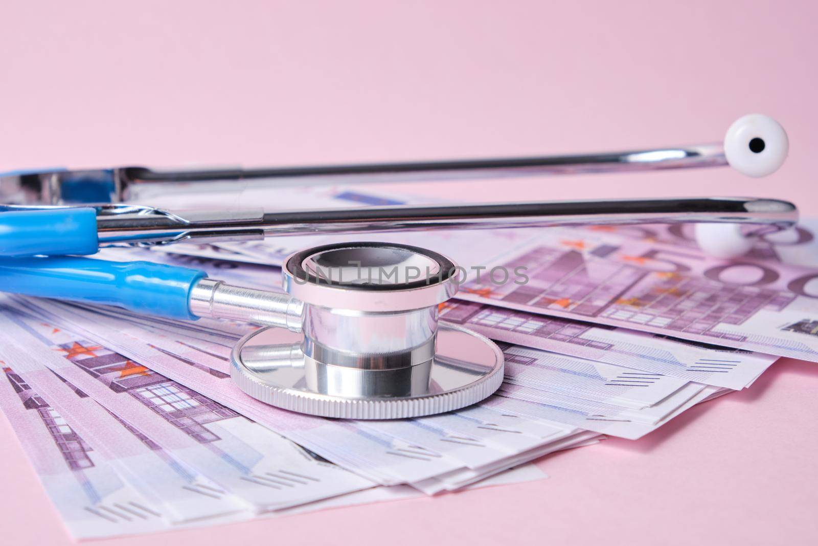 stethoscope and euro banknotes on a pink background, a symbol of stability, growth and fall of currencies, monitoring the exchange rate on the exchange