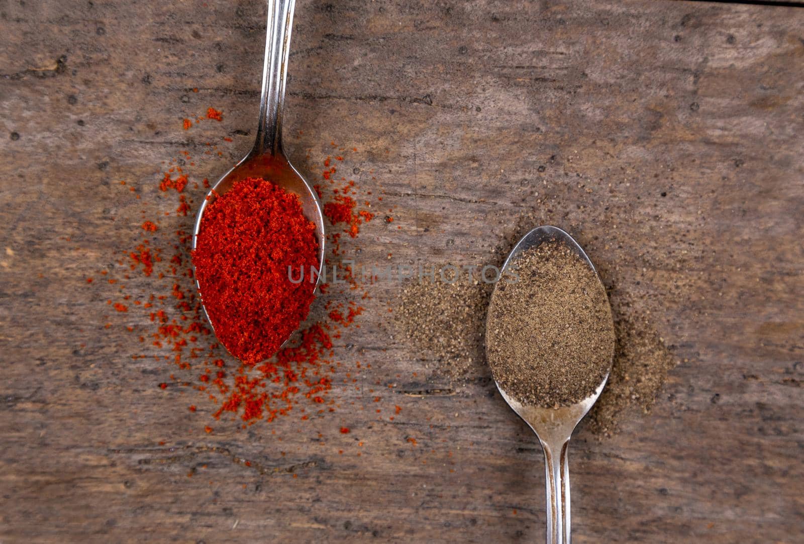 Bright spices over wooden background. Cooking or spicy food concept. Top view.