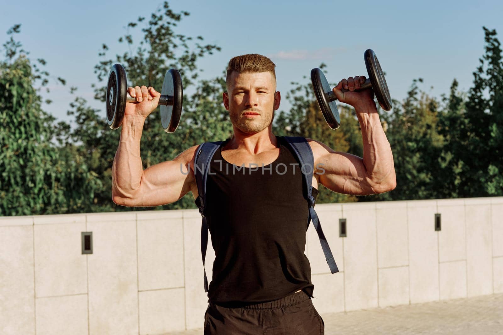 athletic man with dumbbells with pumped up body workout by Vichizh