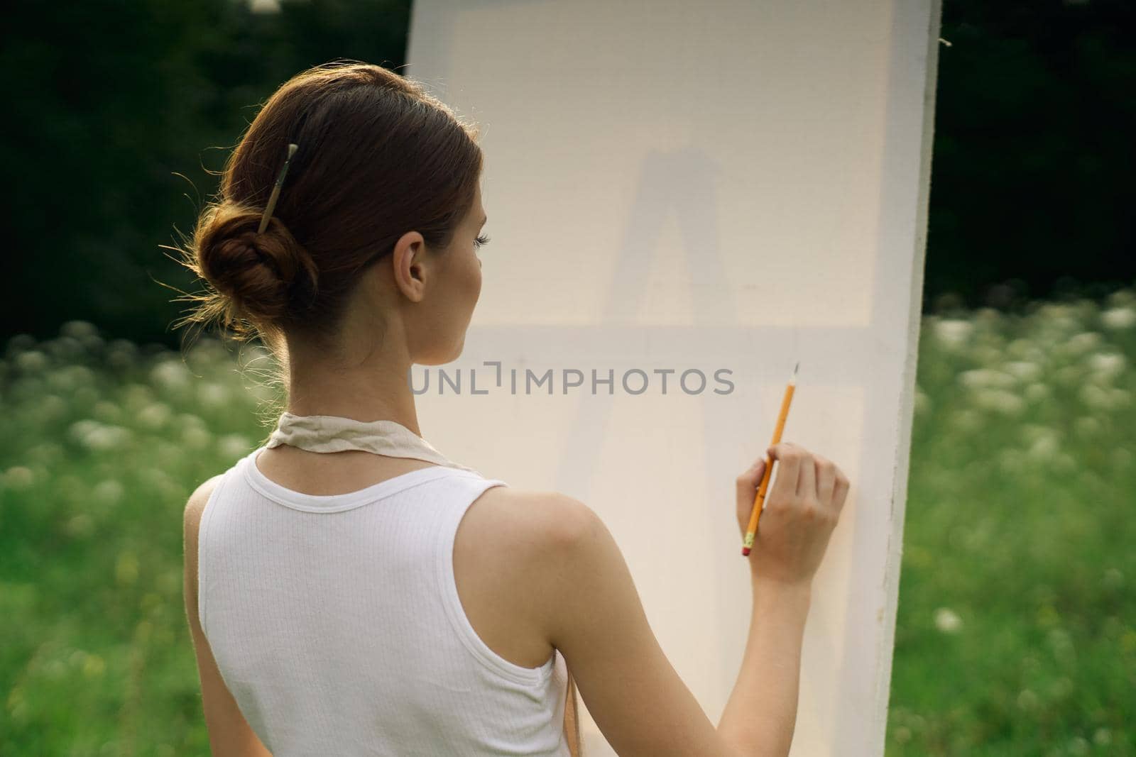 woman artist in aprons in nature draws a picture art by Vichizh