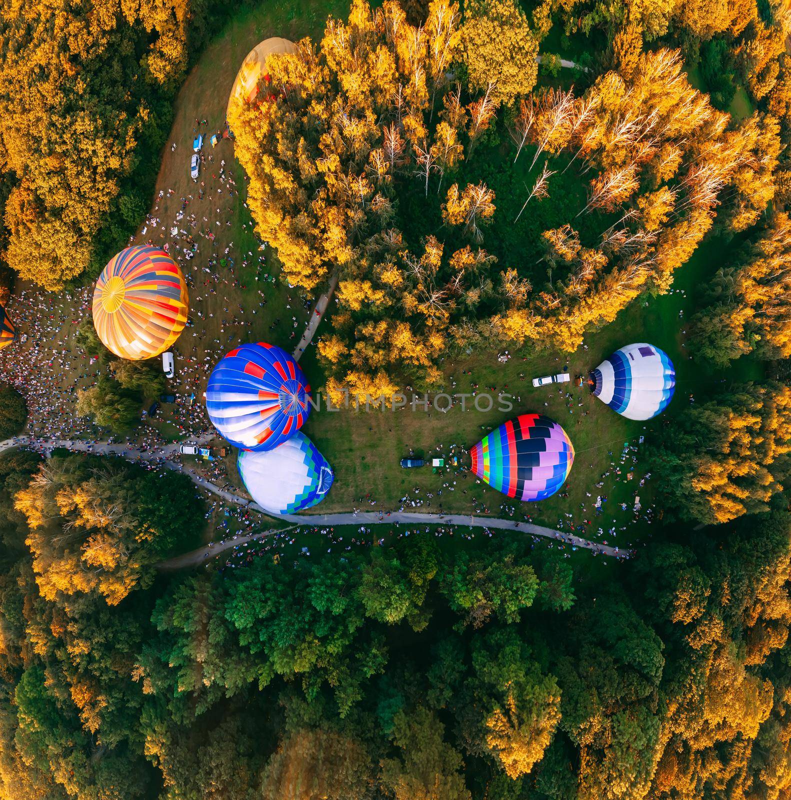 Panoramic air view of hot air ballons prepare for an early morning takeoff from park in small european city, Kiev region, Ukraine