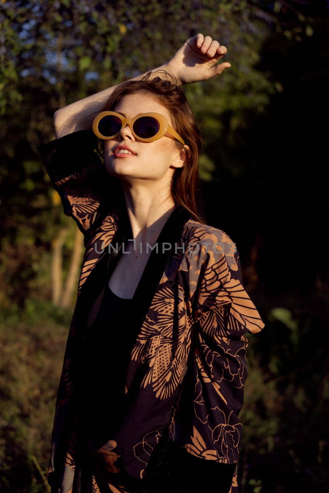 woman wearing sunglasses outdoors posing fashion. High quality photo