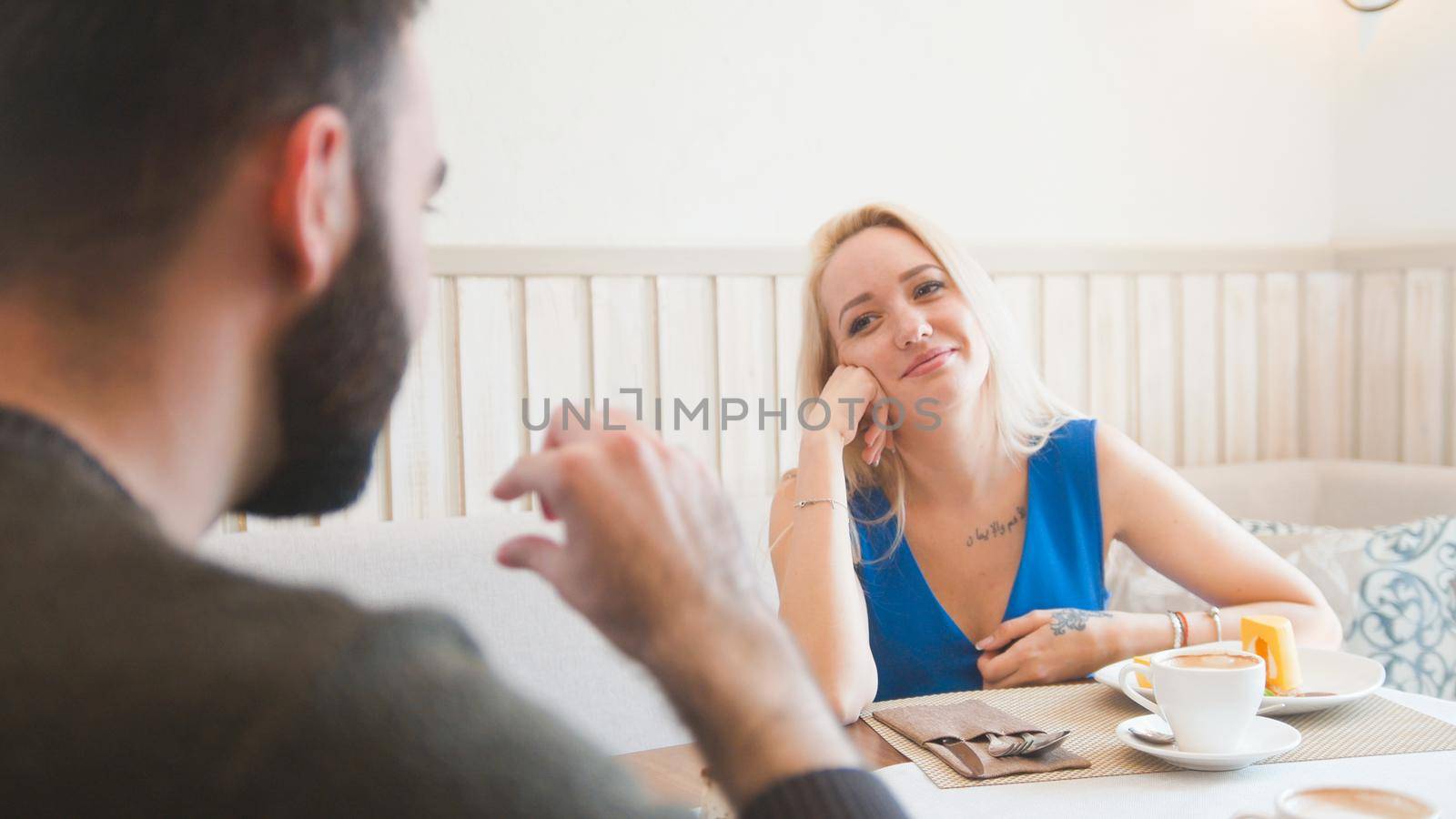 Guy and a girl in a cafe, telephoto shot