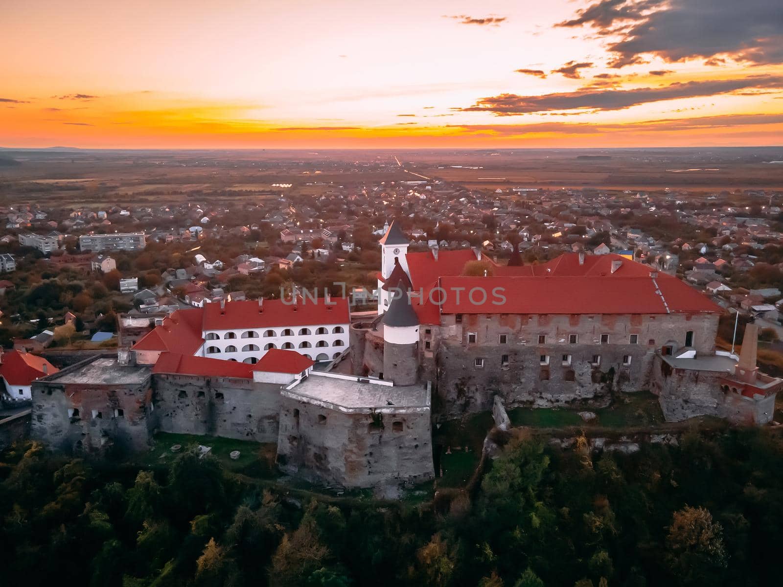 Aerial view of medieval castle on mountain in small european city in autumn season. Palanok castle, Mukachevo, Ukraine