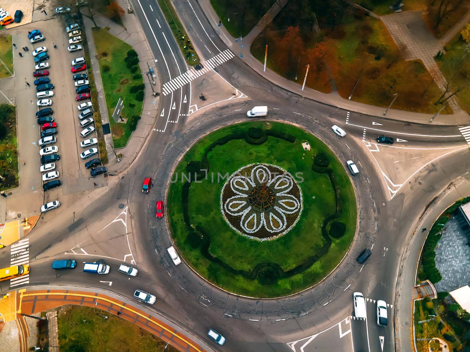 Aerial view of roundabout road with circular cars in small european city at autumn cloudy day, Kyiv region, Ukraine