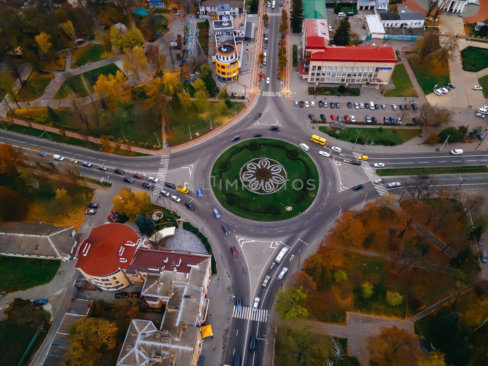 Aerial view of roundabout road with circular cars in small european city at autumn cloudy day, Kyiv region, Ukraine