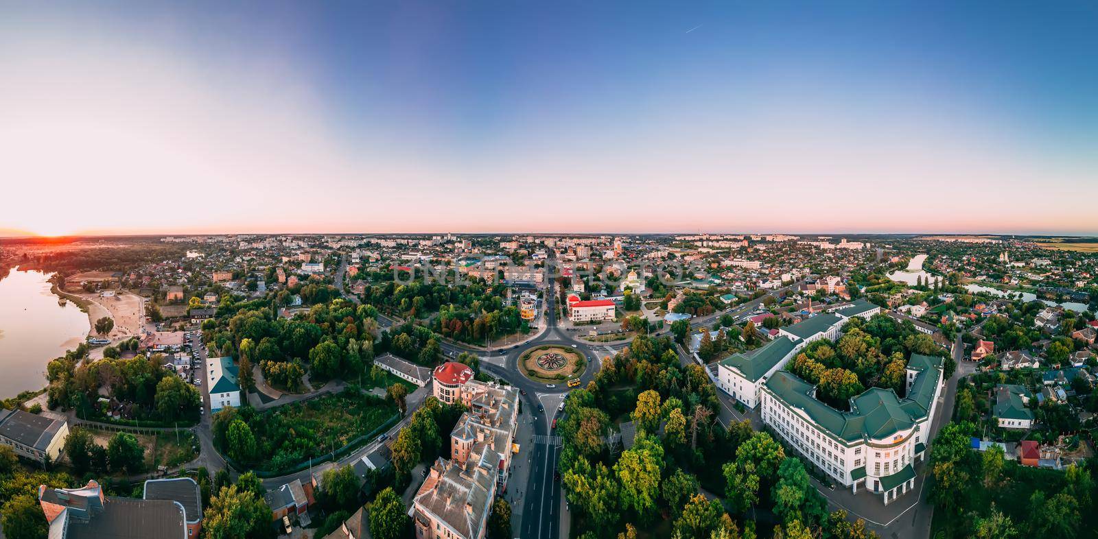 Aerial panorama view of roundabout road with circular cars in small european city at cloudy autumn day by OnPhotoUa