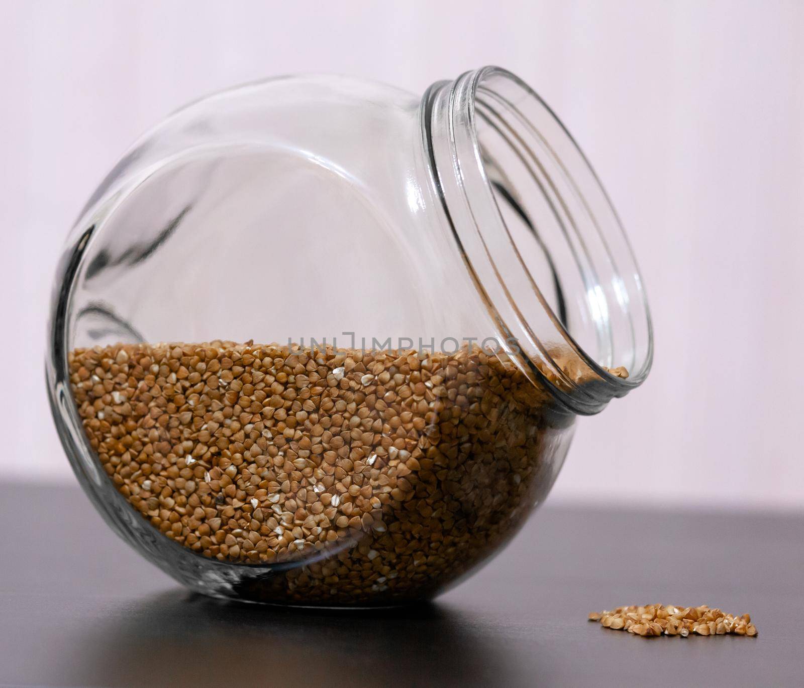 Healthy food buckwheat in a glass jar is on the table