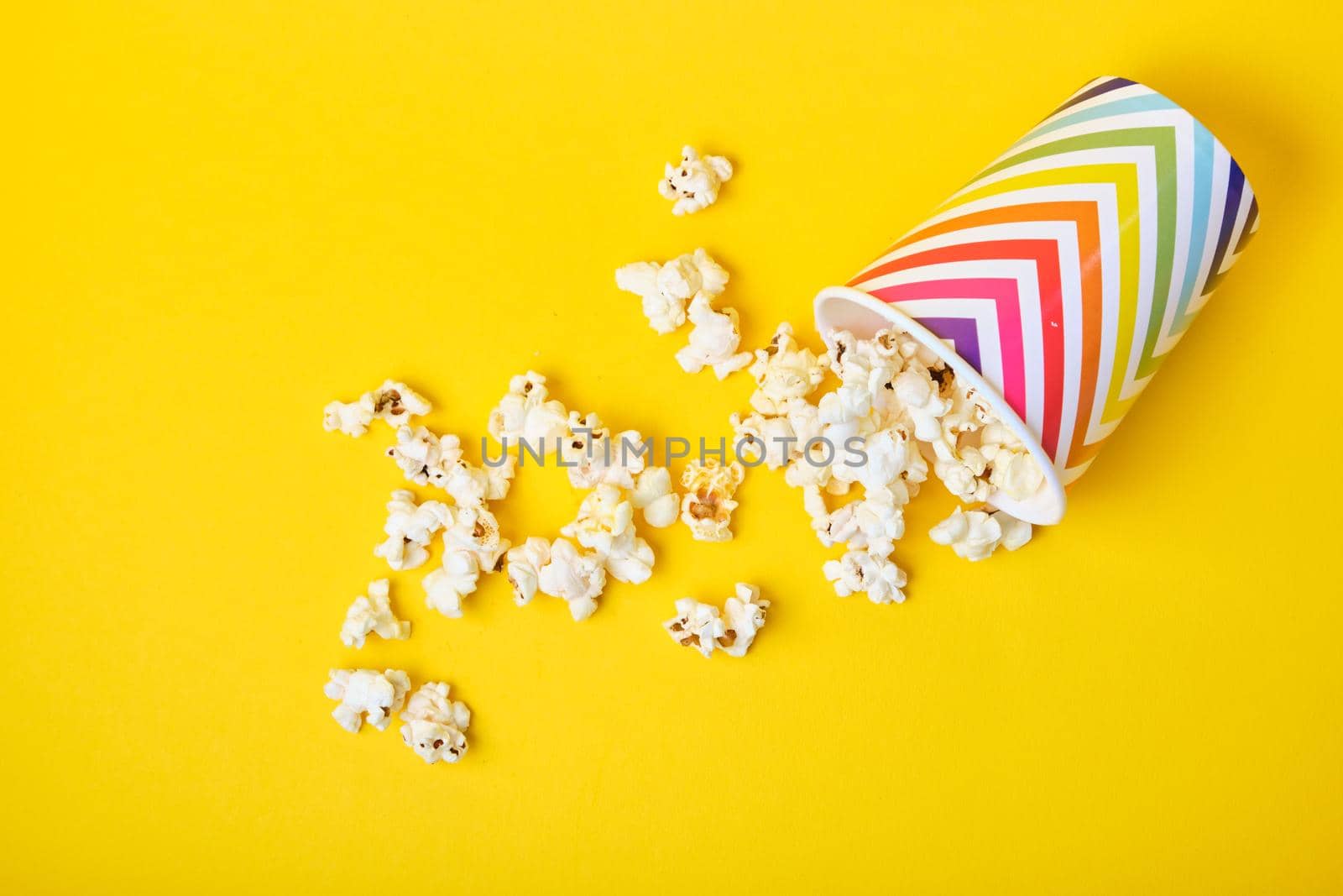 popcorn in bright holiday paper cup on yellow background