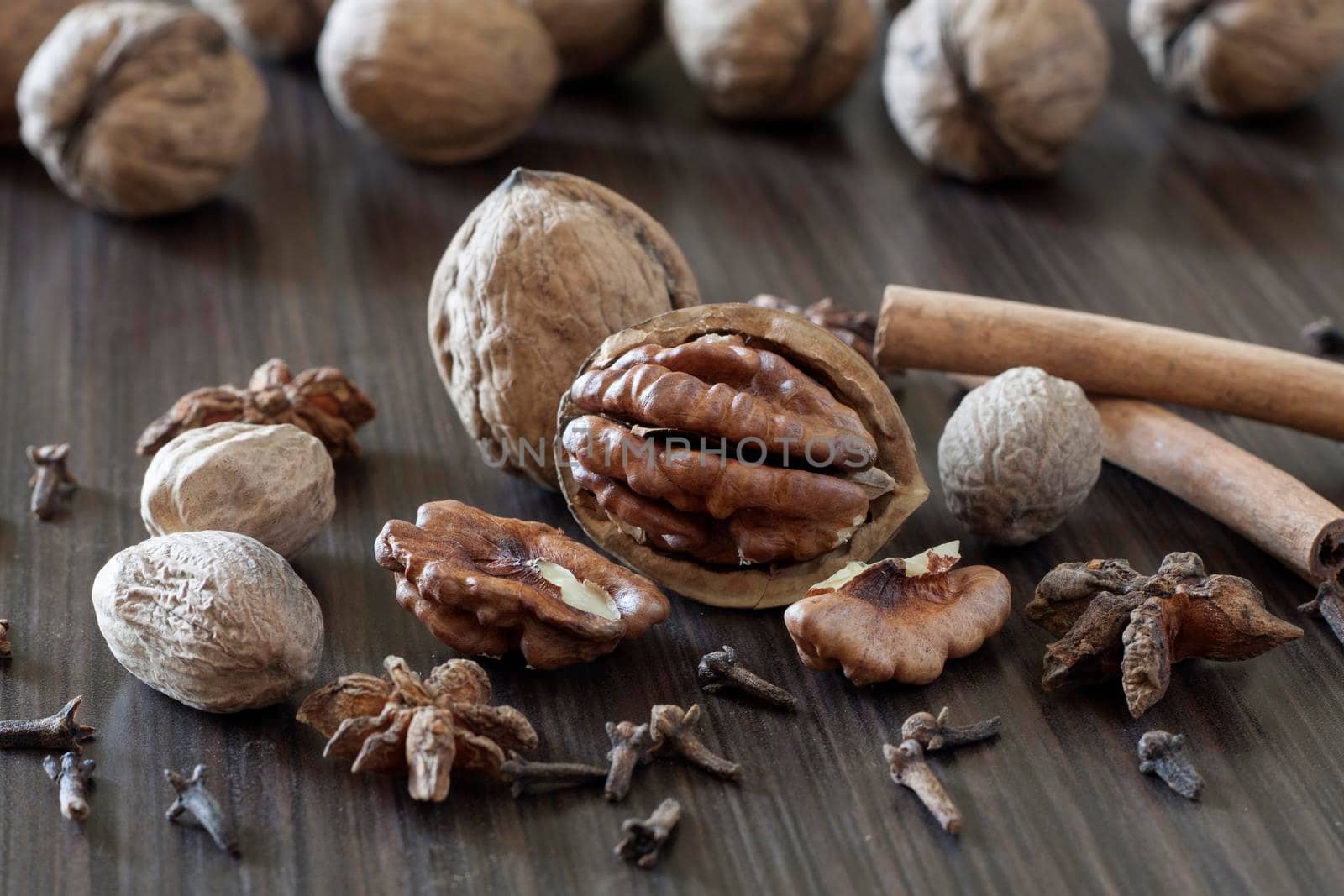 Walnuts and spices on a dark background