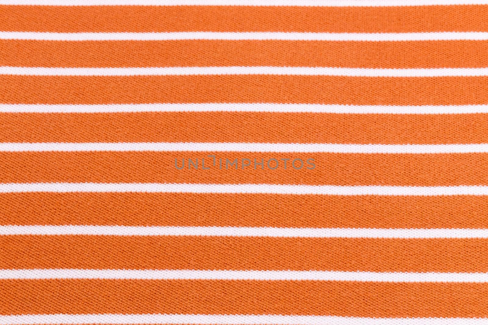 Beautiful summer background made of striped fabric of delicate colors orange
